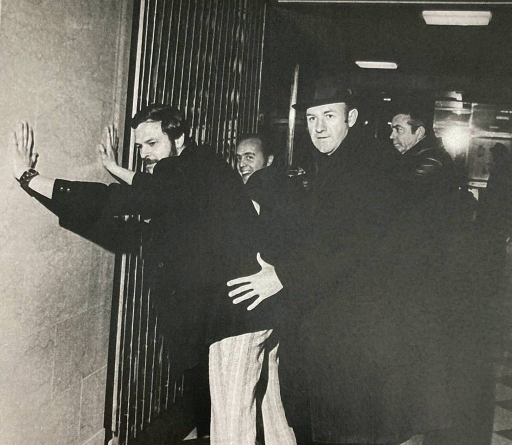 Gene Hackman pats down NYPD Detective Randy Jurgensen to learn proper police procedures to use in the filming of The French Connection. Jurgensen was a guest on the True Crime Reporter™ podcast.