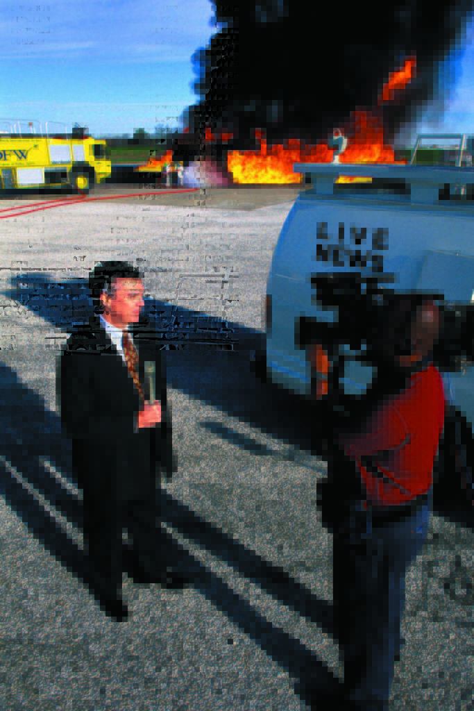 Reporter Robert Riggs at the DFW Airport Firefighter Training Drill with Photographer Cliff Williams of WFAA-TV Channel 8 News