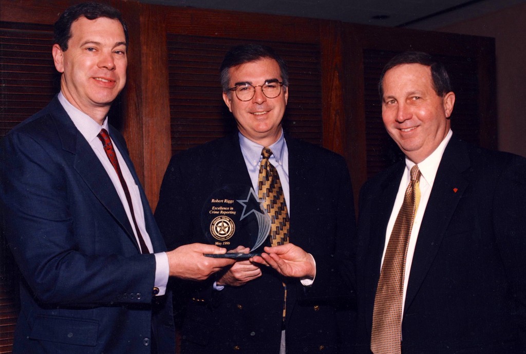 United States Attorney Paul Coggins and FBI Agent Tase Bailey (Retd.) present Robert Riggs with the Dallas Crime Commission's Excellence in Reporting Award. Reporter Robert Riggs was recognized for his investigative series on check fraud, identify theft, and black tar heroin trafficking that killed more than two dozen teenagers in Plano, Texas.